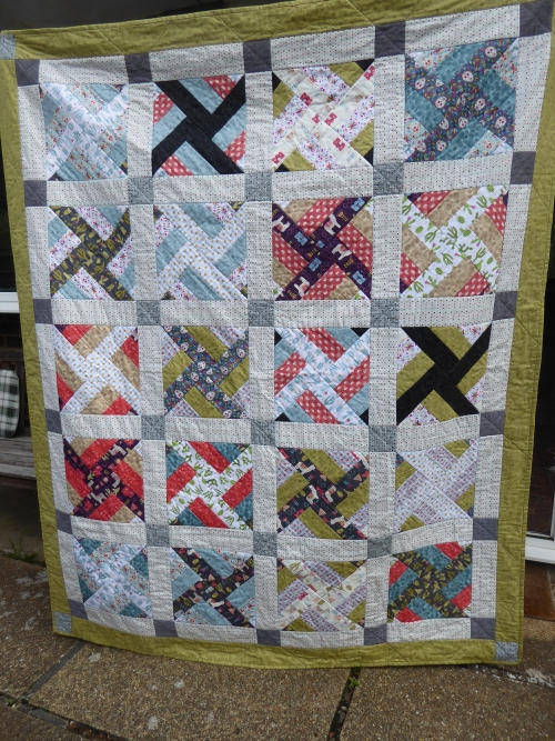 Traditional quilt made of blocks with windmill patterns by Mary Cunningsworth