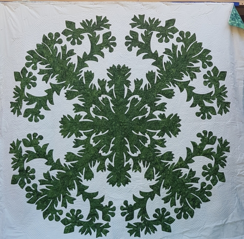 Quilt by Pippa Moss. Green damask style pattern on white background