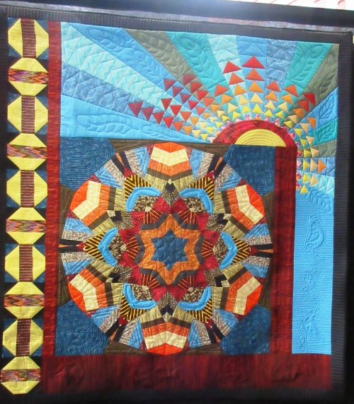 Multicoloured quilt depicting star and sun motifs