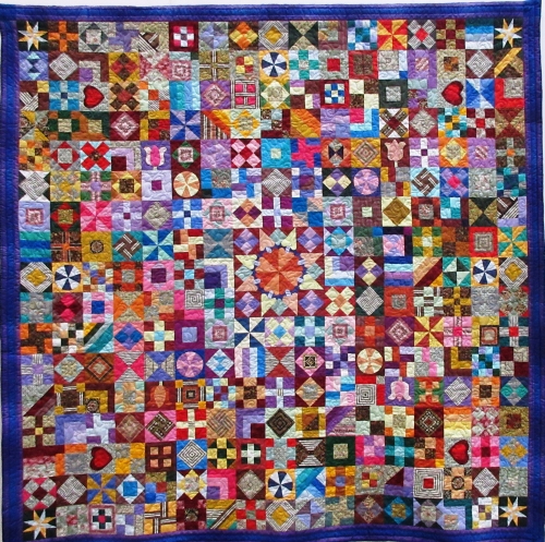 Square quilt made of many squares made of lots of different shapes and colours