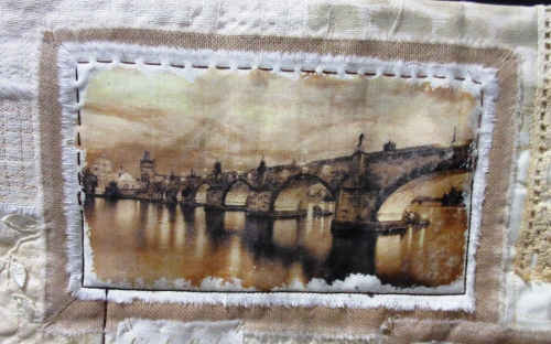 Close up of quilt depicting a photo of a bridge