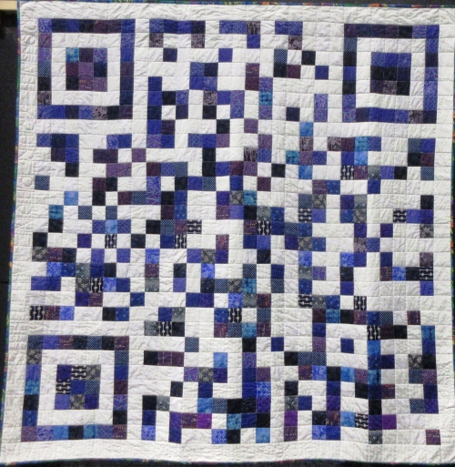 Quilt made of white, blue, purple and grey small squares